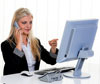 Person on the telephone working on a computer