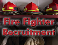 Fire fighter helmets on a shelf with jackets hung below