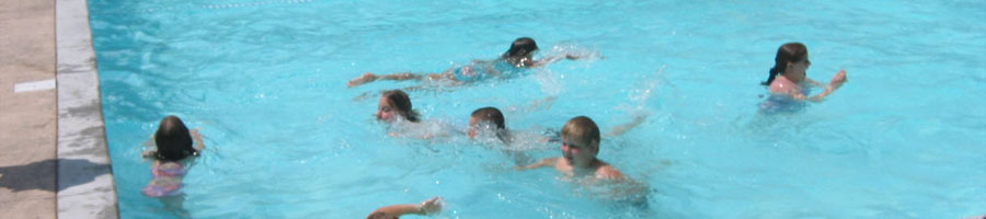 Kids in the summer swimming at a public pool