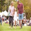 mother, father, and child, walking in the park, smiling