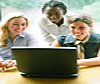 People gathered around a laptop